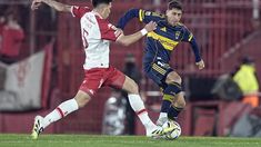 Pérez, volante del Globo, disputa la pelota con Merentiel, del Xeneize. Pérez, volante del Globo, disputa la pelota con Merentiel, del Xeneize.